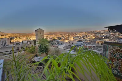 a view of a city with a clock tower at Riad Les Idrissides Chez LEA in Fès