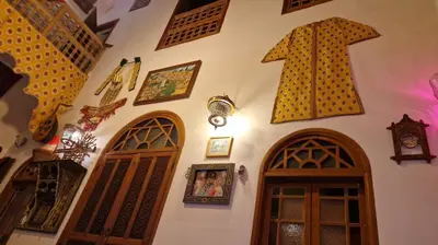a wall with a bunch of clocks and doors at Riad Les Idrissides Chez LEA in Fès