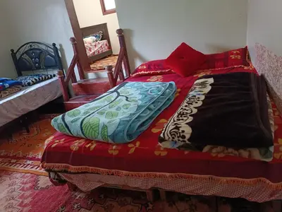 a bedroom with a bed with pillows on it at Auberge Toubkal Amsouzart Aitst Idar in Tizgui