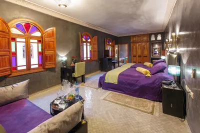 a bedroom with a bed and a couch in a room at Riad Andalib in Fès