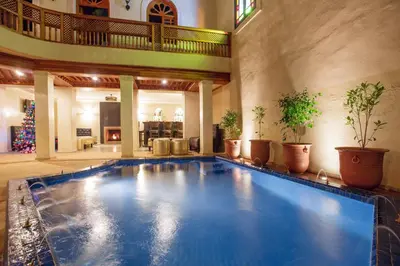 a large swimming pool in a large house at Riad Andalib in Fès