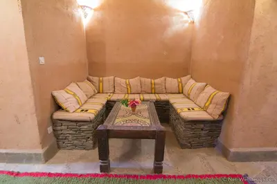 a living room with a couch and a table at Kasbah Imdoukal in Nkob