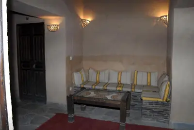 a living room with a couch and a table at Kasbah Imdoukal in Nkob