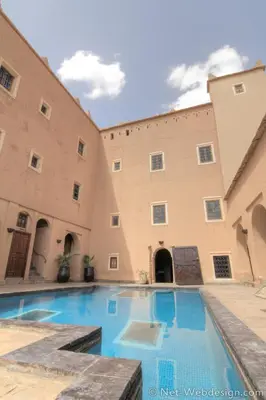 a pool in the courtyard of a building at Kasbah Imdoukal in Nkob
