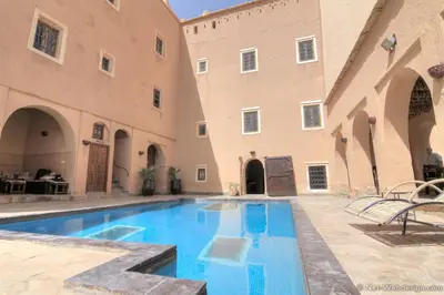 a courtyard with a swimming pool in a building at Kasbah Imdoukal in Nkob