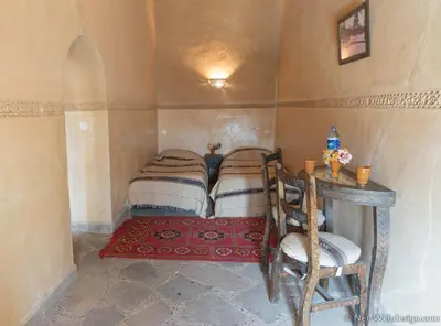 a room with four beds in a small room at Kasbah Imdoukal in Nkob