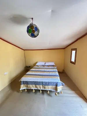 a bedroom with a bed in a room at Auberge L'Oasis Mhamid in Mhamid