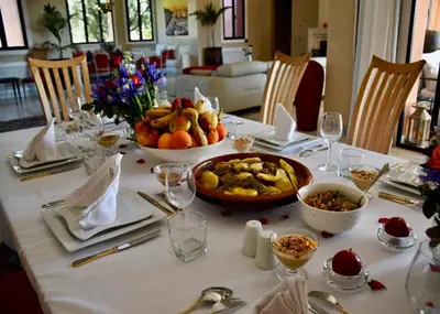 a table with a plate of food on it at Villa Koutoubia, jardin luxuriant, piscine et spa in Marrakech