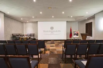 a conference room with chairs and a projection screen at Palais Medina Riad Resort in Fès