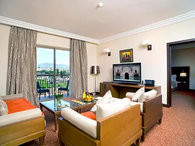a living room with two couches and a balcony at Palais Medina Riad Resort in Fès