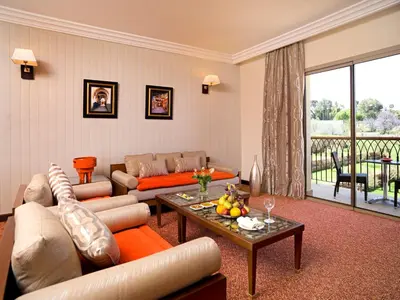 a living room with a couch and a table at Palais Medina Riad Resort in Fès