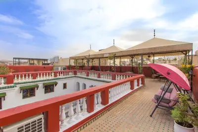 a view of the balcony of a building with a umbrella at Riad Dar Skalli & SPA in Fès