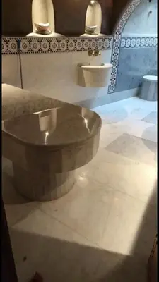 a large stone bowl in a bathroom with two sinks at Riad Dar Skalli & SPA in Fès