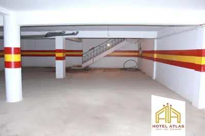 an empty room with a staircase in a building at Hôtel Atlas Guercif in Guercif