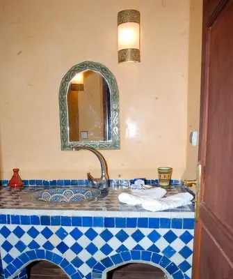 a bathroom with a sink and a mirror at Riad Le Patio De Fes in Fès