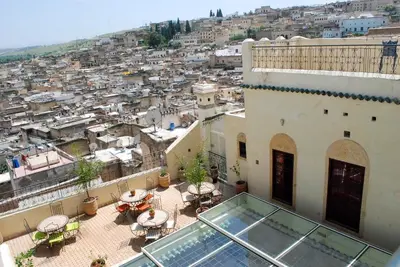 a balcony of a building with a view of a city at Riad Le Patio De Fes in Fès