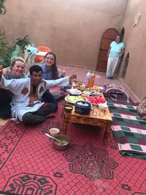 a group of people sitting around a table at Dar Yaya in Mhamid