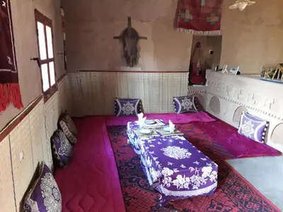 a room with a table with a purple table cloth at Dar Yaya in Mhamid