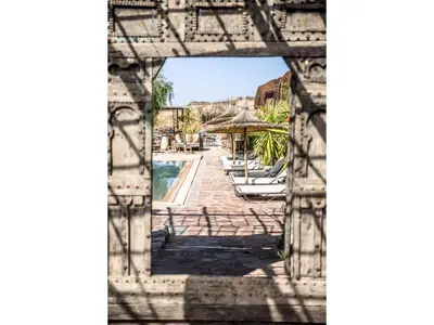 an archway with a view of a swimming pool at Dar Tafantant in Marrakech