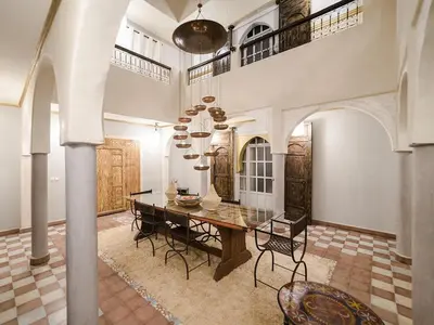 a large dining room with a table and chairs at Dar Tafantant in Marrakech