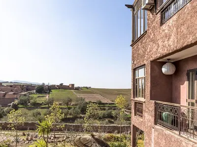 a building with a balcony with a view of a hill at Dar Tafantant in Marrakech