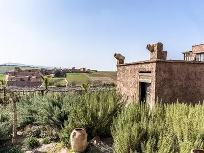 an old building in the middle of a field at Dar Tafantant in Marrakech