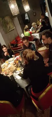 a group of people sitting at a table in a restaurant at Dar Tadout in Aït Ourir