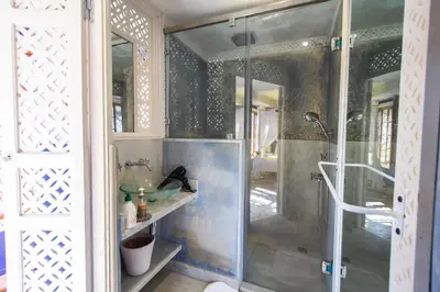 a bathroom with a shower with a glass door at Riad 53 Fes - Luxury Oasis in Fès