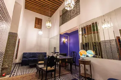 a living room with a blue couch and a table at Riad 53 Fes - Luxury Oasis in Fès