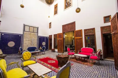 a living room with colorful chairs and tables at Riad 53 Fes - Luxury Oasis in Fès