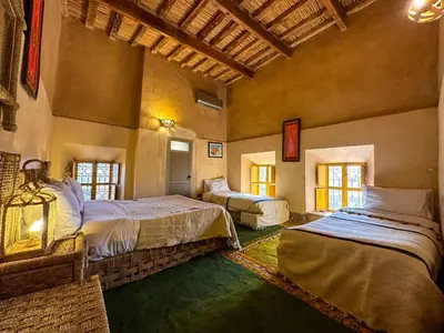 a large room with two beds in a building at Kasbah Baha Baha in Nkob