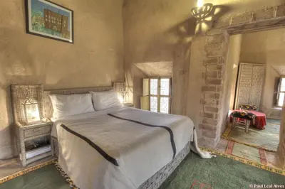 a bedroom with a large bed in a room at Kasbah Baha Baha in Nkob