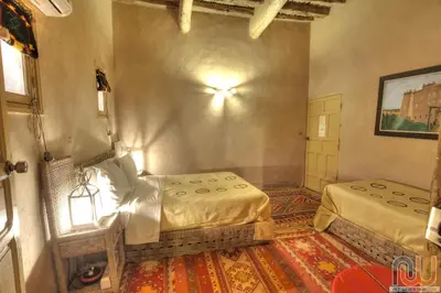a bedroom with two beds in a room at Kasbah Baha Baha in Nkob