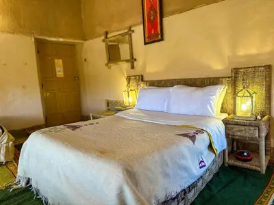 a bedroom with a large bed in a room at Kasbah Baha Baha in Nkob