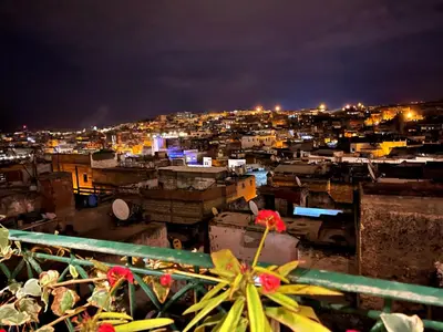 a view of a city at night at Riad Dar Guennoun - Luxury Suites in the Heart of Fes in Fès