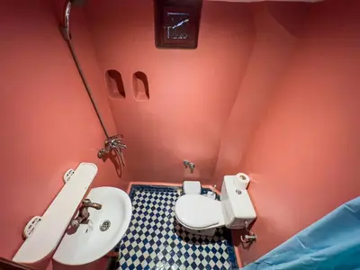 a small bathroom with a toilet and a sink at Riad Dar Guennoun - Luxury Suites in the Heart of Fes in Fès