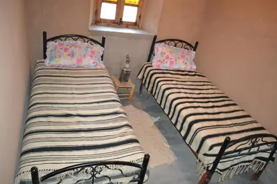 two beds sitting next to each other in a room at GITE D'etape SIDI FLAH in Sidi Flah