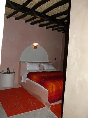 a bedroom with a bed in a room at Palmeras Y Dunas Luxery Camp in Merzouga