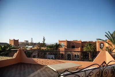 a balcony with a table and a view of the city at Oscar Hotel by Atlas Studios in Ouarzazate