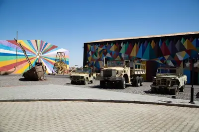 a group of military vehicles parked in front of a building at Oscar Hotel by Atlas Studios in Ouarzazate