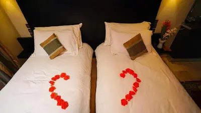 a couple of beds with red hearts on them at Palais Riad Reda & Spa in Fès
