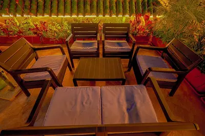 a group of chairs and tables on a patio at Palais Riad Reda & Spa in Fès