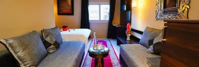 a living room with two couches and a bed at Palais Riad Reda & Spa in Fès