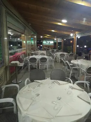 a dining room with white tables and chairs at Hôtel Hadaik Ain Asserdoune in Beni Mellal