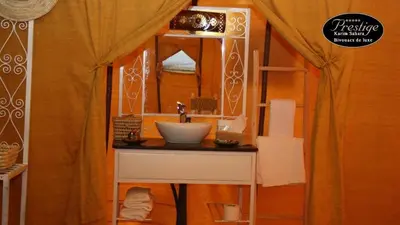 a bathroom with a sink and a mirror at Karim Sahara Prestige in Zagora