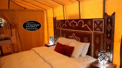 a bedroom with a large bed in a tent at Karim Sahara Prestige in Zagora