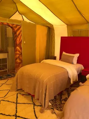 a bedroom with a bed in a tent at Karim Sahara Prestige in Zagora