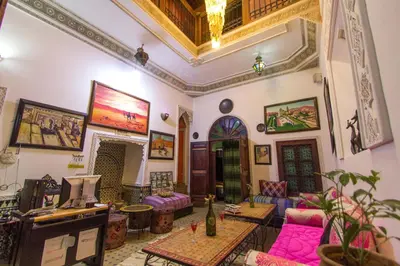 a living room with pink furniture and a ceiling at Riad Anass Al Ouali in Fès