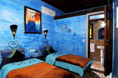 a blue room with two beds and a sink at Riad Anass Al Ouali in Fès