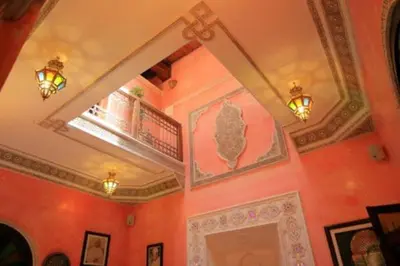 a room with red walls and a ceiling with a window at Riad Anass Al Ouali in Fès
